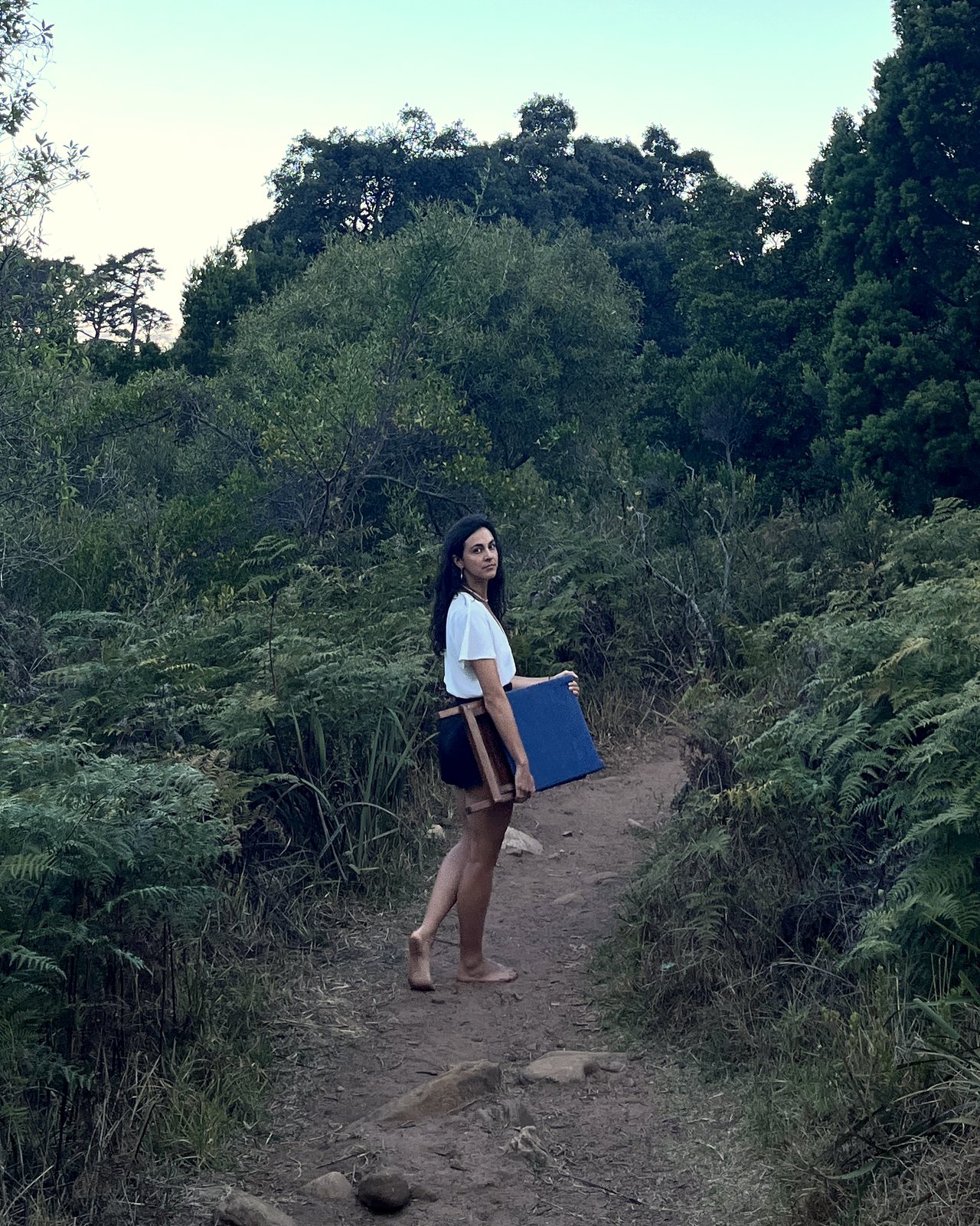 Carrying the folded kiaat chair along a mountain path